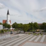 A view of Šiauliai, Lithuania featuring a prominent church and city square.